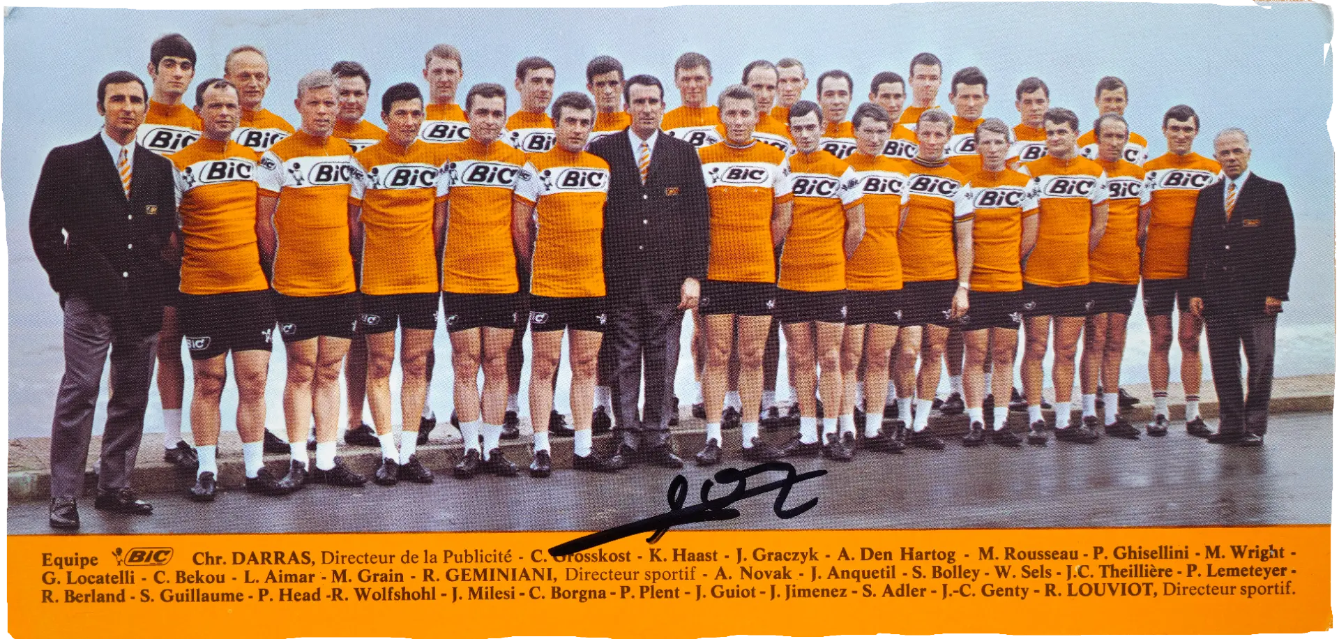 The full BiC team lined up in orange jerseys, signed